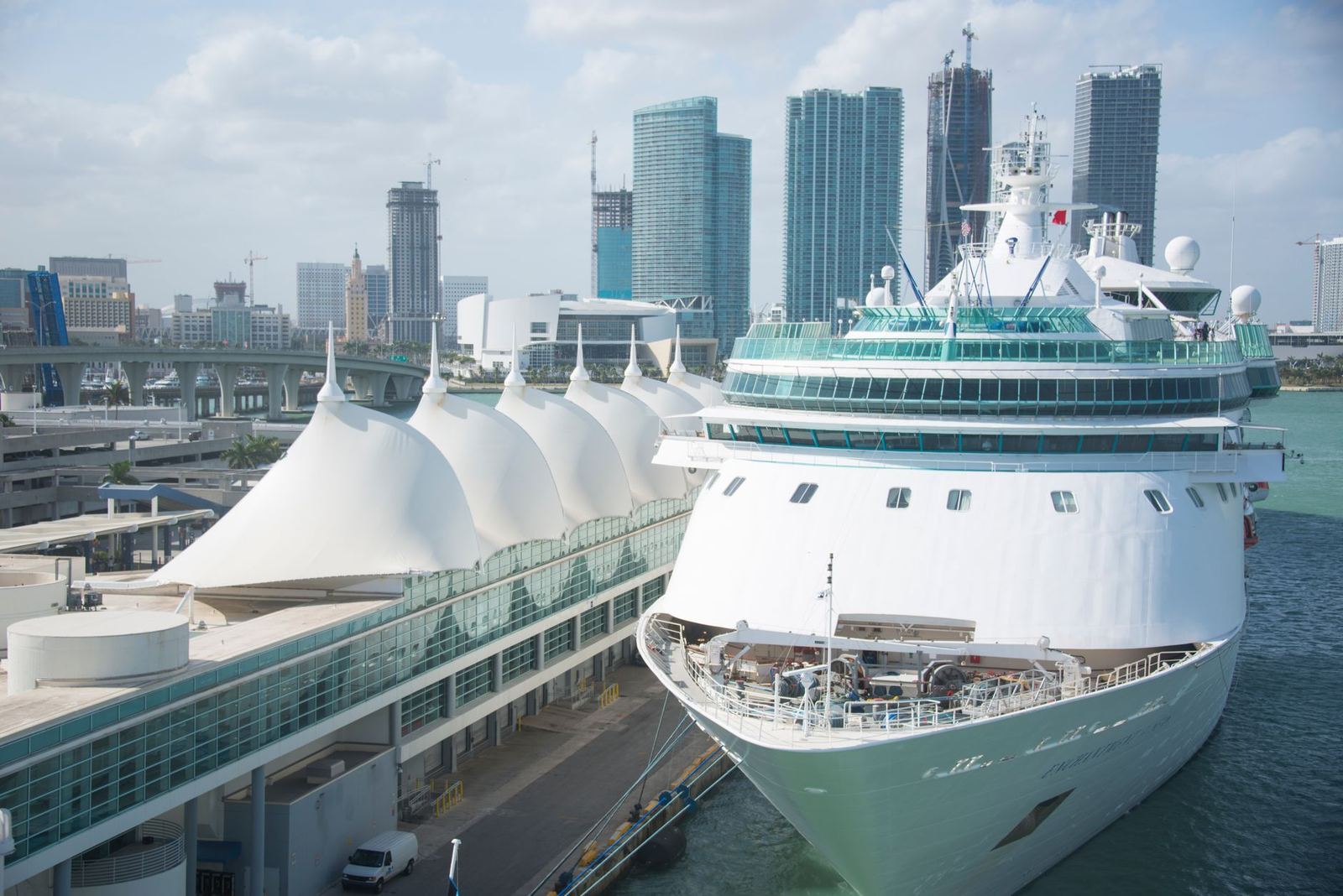 A cruise ship berthed at a modern waterfront terminal