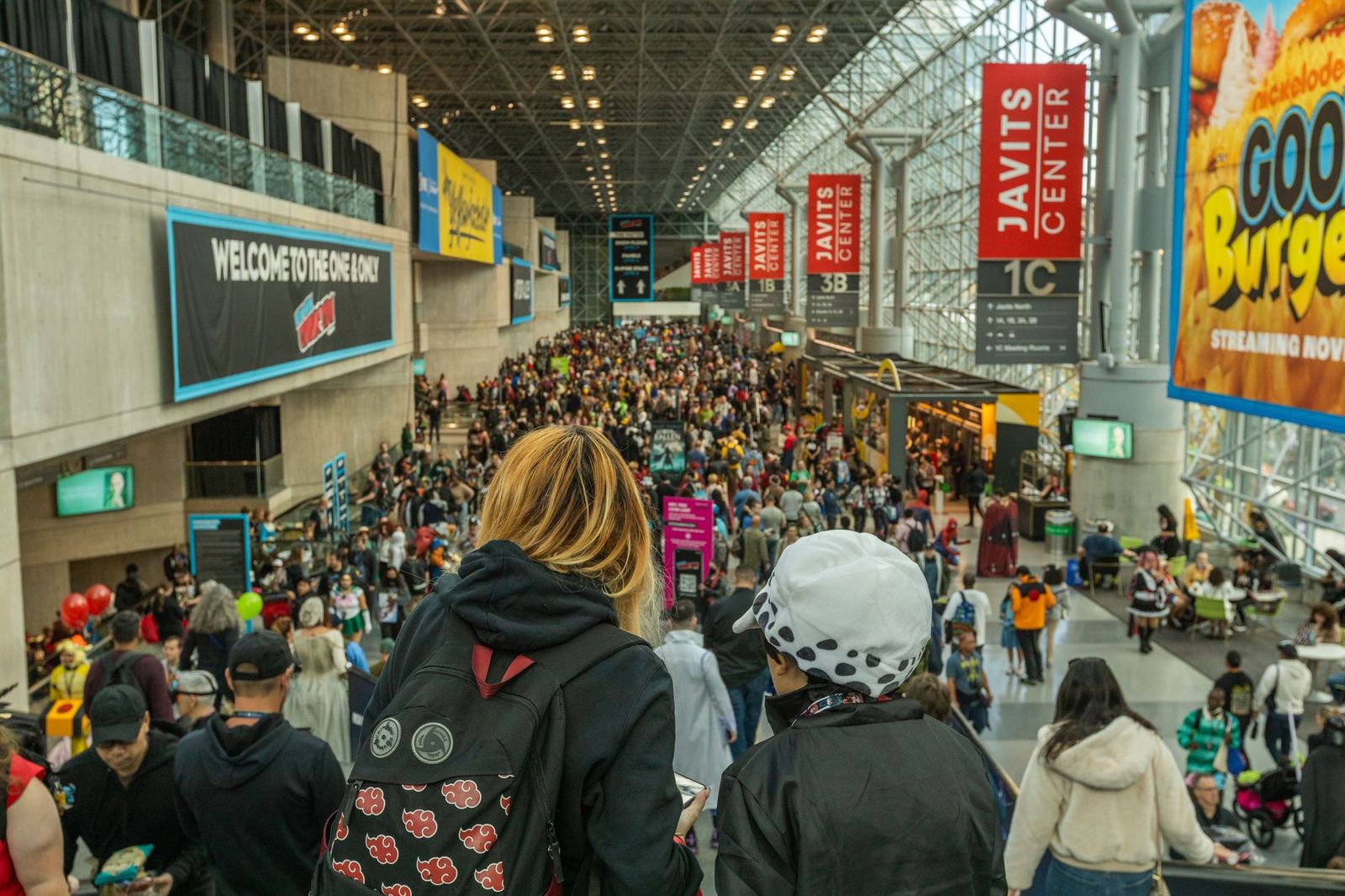 Crowds moving through the entrance hall of a large convention centre